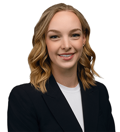Caroline OBrien, with shoulder-length wavy blonde hair, is wearing a black blazer and white top, smiling at the camera against a plain background.