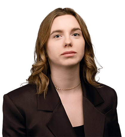 Daria Smirnova, with shoulder-length light brown hair, wears a dark blazer and a thin chain necklace, looking forward with a neutral expression.