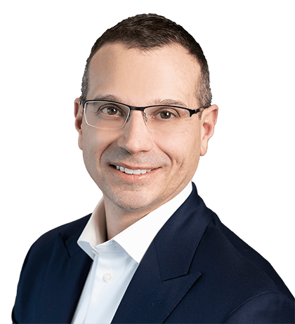 Fabio Ventolini, a man with short brown hair and glasses, is wearing a navy suit jacket and white shirt, smiling at the camera against a plain background.
