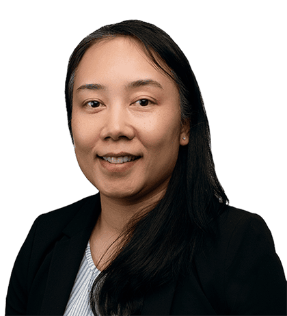 Linda Inthahack, a woman with long black hair wearing a black blazer and light-colored top, smiles at the camera against a plain background.