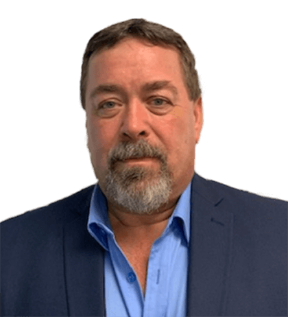 A middle-aged man with short brown hair, a beard, and mustache—Robert Boutilier—wears a blue dress shirt and dark blazer, facing forward against a plain background.