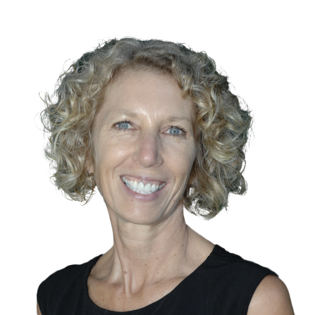 Jennie Moore, a woman with short, curly blonde hair and blue eyes, smiles at the camera. She is wearing a sleeveless black top and is pictured against a plain white background.