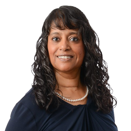 Nadira Harvey, a woman with long, curly dark hair, smiles at the camera in a navy blue top and pearl necklace against a white background.