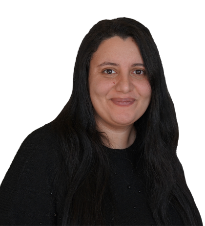 Woman with long dark hair and a black top smiling at the camera against a plain white background.