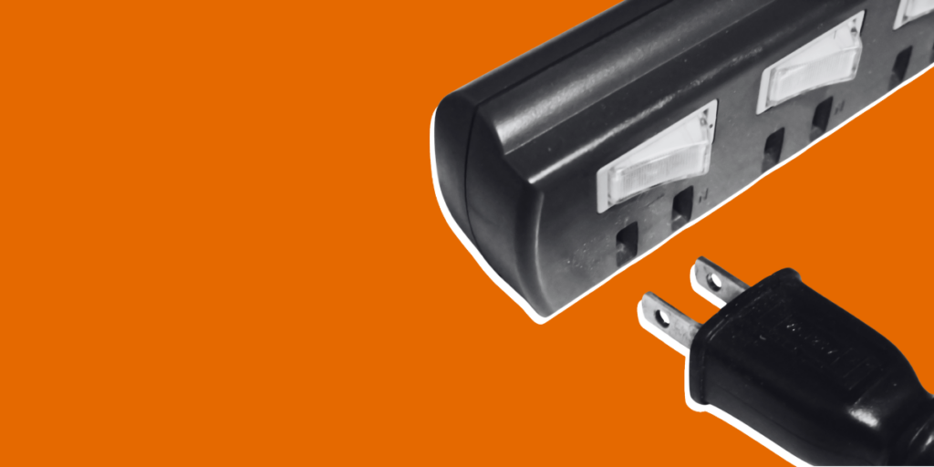 A stark orange background with a black-and-white image of a cable being unplugged from a power bar, signifying how AI was taken offline.